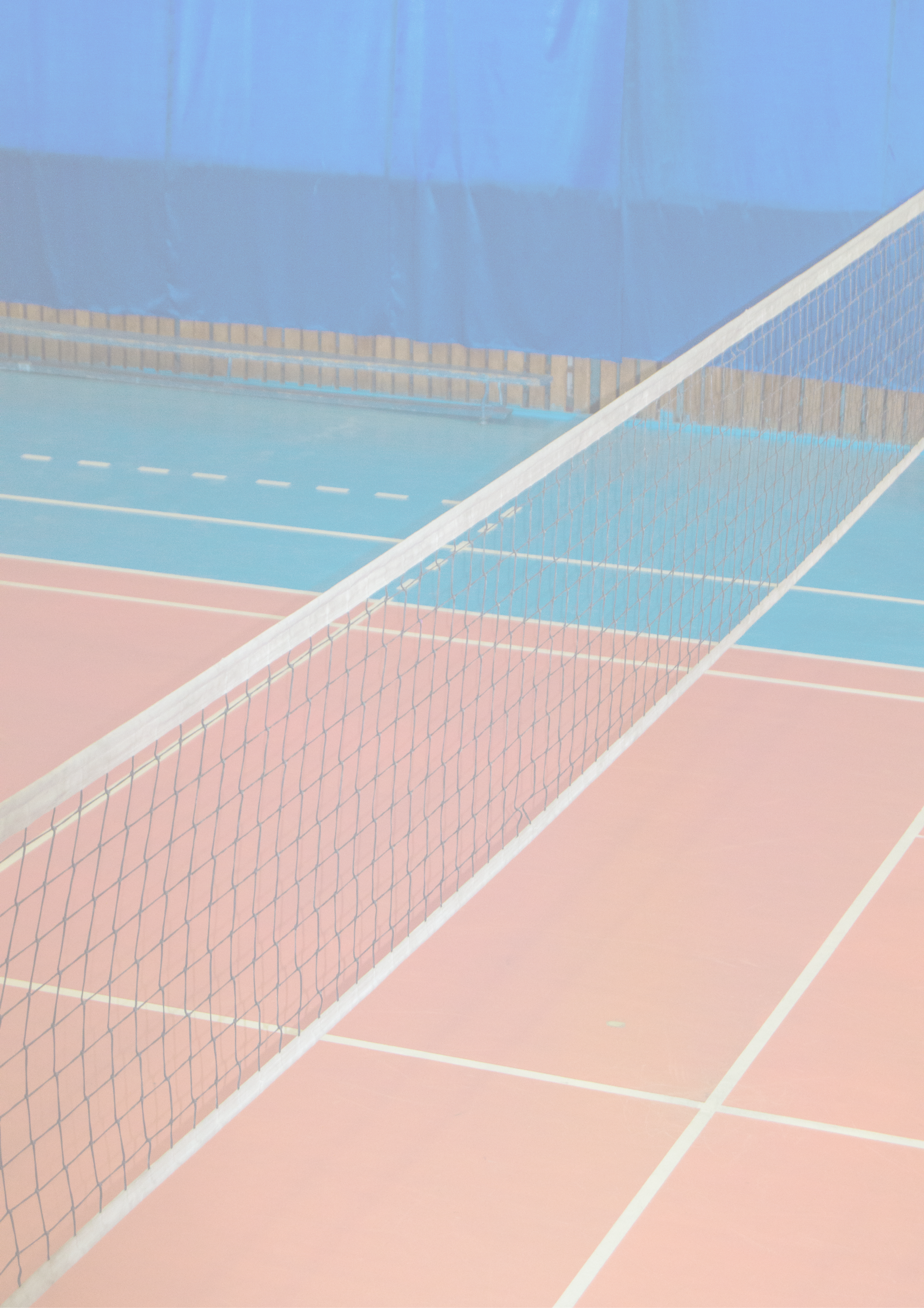 Empty gym with a stretched net for volleyball, against the background of orange and blue floor  Space for text  The concept of active sports, Hobbies, vertical frame 
